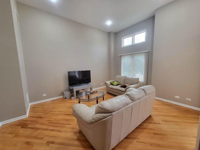 3041 W Pope John Paul Ii Dr, Chicago, IL 60638 - living room with baseboards, light wood-style floors, and a towering ceiling