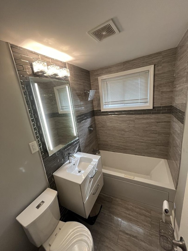 207 Mantua St, Park Forest, IL 60466 - bathroom with toilet, vanity,  shower combination, and tile walls