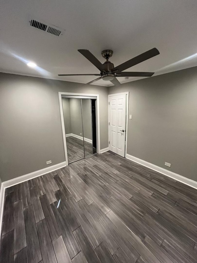 207 Mantua St, Park Forest, IL 60466 - unfurnished bedroom with dark wood-style floors, baseboards, a closet, and a ceiling fan