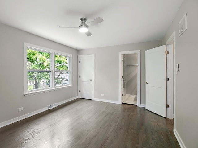 17708 Pebblewood Ln, Hazel Crest, IL 60429 - unfurnished bedroom featuring dark wood-style flooring, baseboards, ensuite bath, and ceiling fan
