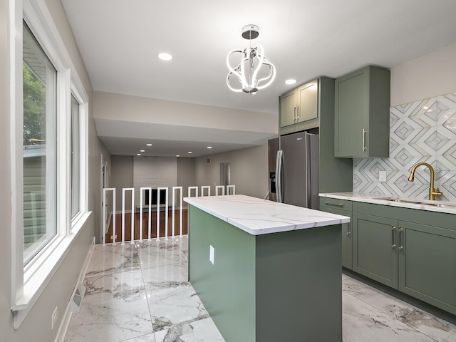 17708 Pebblewood Ln, Hazel Crest, IL 60429 - kitchen with green cabinetry, a sink, stainless steel fridge, light marble finish flooring, and recessed lighting