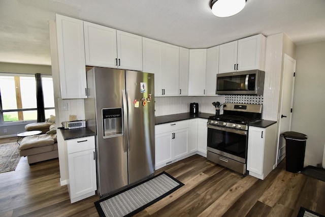 401 W Boundary St, Stanford, IL 61774 - kitchen with stainless steel appliances, dark countertops, tasteful backsplash, and dark wood finished floors