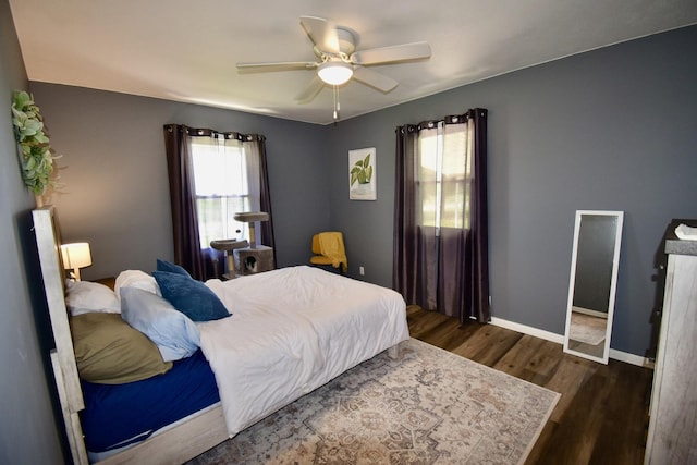 401 W Boundary St, Stanford, IL 61774 - bedroom featuring multiple windows, dark wood finished floors, baseboards, and ceiling fan