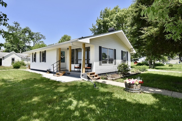 401 W Boundary St, Stanford, IL 61774 - ranch-style house featuring a front yard, covered porch, and a chimney
