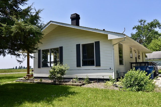 401 W Boundary St, Stanford, IL 61774 - view of property exterior with a chimney and a yard