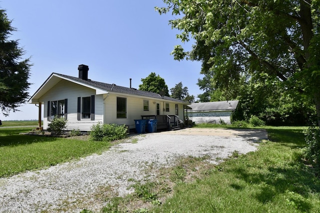 401 W Boundary St, Stanford, IL 61774 - back of property with a chimney, driveway, and a yard
