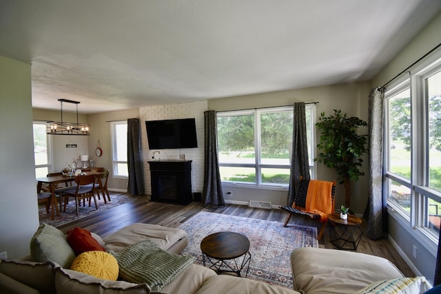 401 W Boundary St, Stanford, IL 61774 - living room with plenty of natural light, wood finished floors, a fireplace, and a chandelier