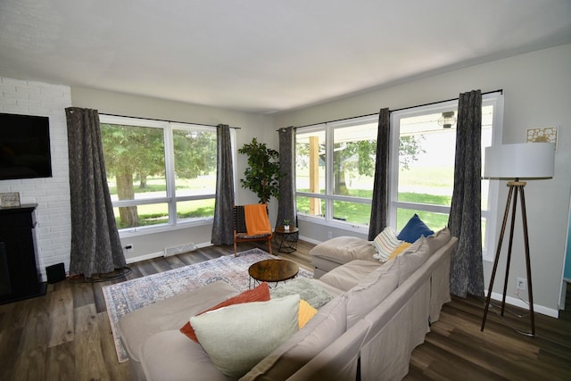 401 W Boundary St, Stanford, IL 61774 - living area with baseboards, wood finished floors, and a brick fireplace