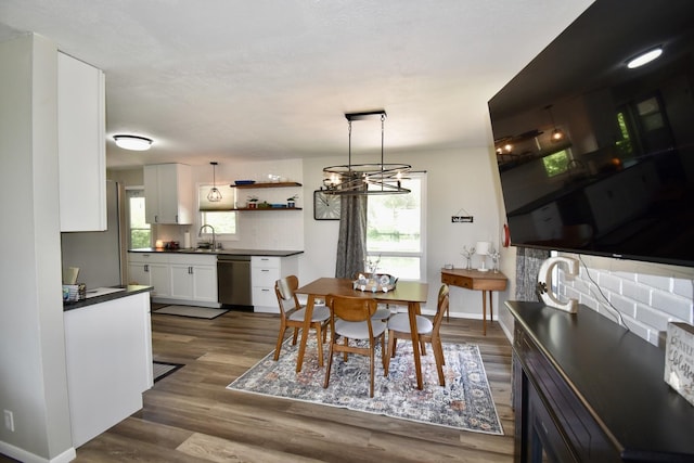 401 W Boundary St, Stanford, IL 61774 - dining area with dark wood-style flooring, a chandelier, and baseboards