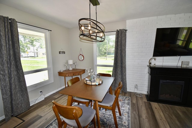 401 W Boundary St, Stanford, IL 61774 - dining area with a chandelier, wood finished floors, a fireplace, and baseboards