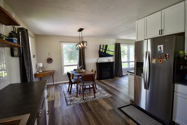 401 W Boundary St, Stanford, IL 61774 - dining room with dark wood-style floors, a brick fireplace, and baseboards