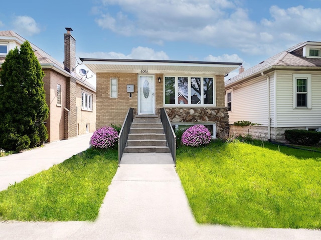 6005 N Canfield Ave, Chicago, IL 60631 - view of front of home featuring a front yard, stone siding, and brick siding