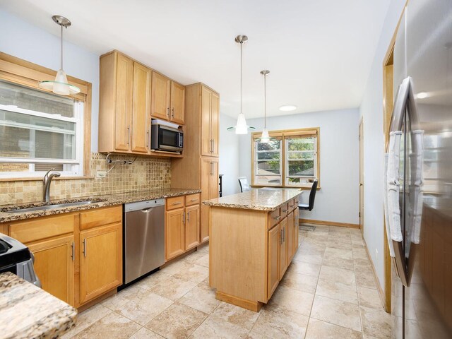 6005 N Canfield Ave, Chicago, IL 60631 - kitchen featuring stainless steel appliances, a sink, backsplash, light stone counters, and a kitchen island