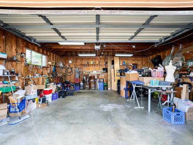 6005 N Canfield Ave, Chicago, IL 60631 - garage with wooden walls, a garage door opener, and a workshop area