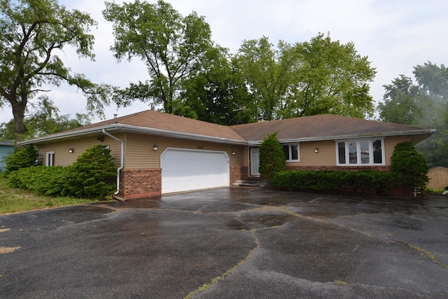 4323 Il Route 176th Ave, Crystal Lake, IL 60014 - ranch-style home with brick siding, an attached garage, and driveway