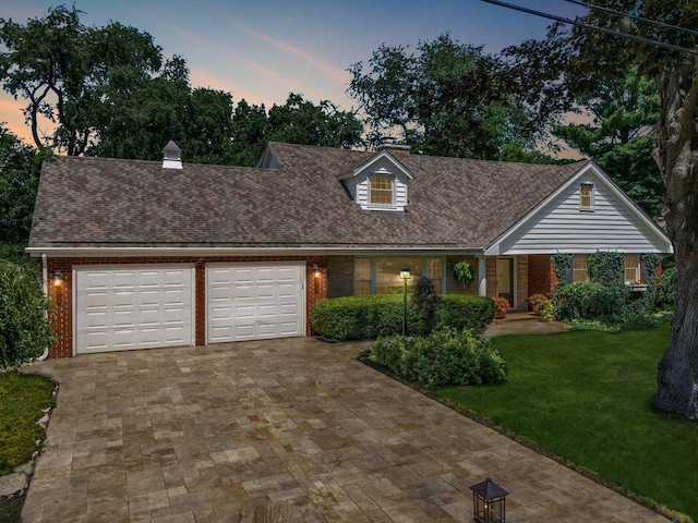 603 Shabbona Trl, Batavia, IL 60510 - cape cod home featuring brick siding, a garage, and decorative driveway