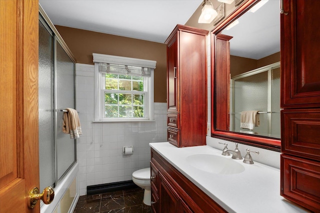 603 Shabbona Trl, Batavia, IL 60510 - bathroom with tile walls, marble look tile flooring, vanity, and combined bath / shower with glass door