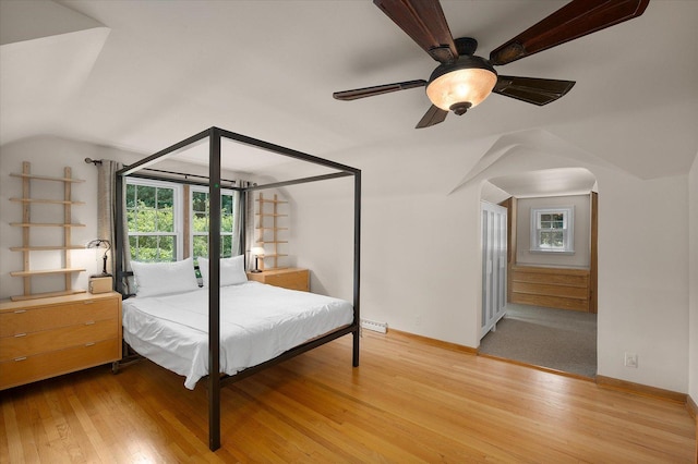 603 Shabbona Trl, Batavia, IL 60510 - bedroom with lofted ceiling, wood finished floors, ceiling fan, and arched walkways