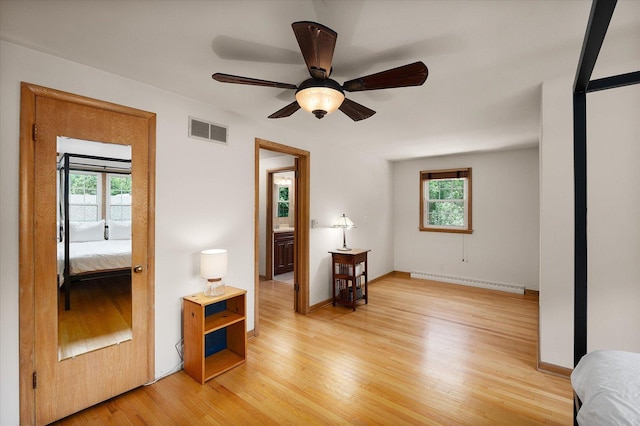 603 Shabbona Trl, Batavia, IL 60510 - spare room with baseboard heating, healthy amount of natural light, light wood-style floors, and a ceiling fan