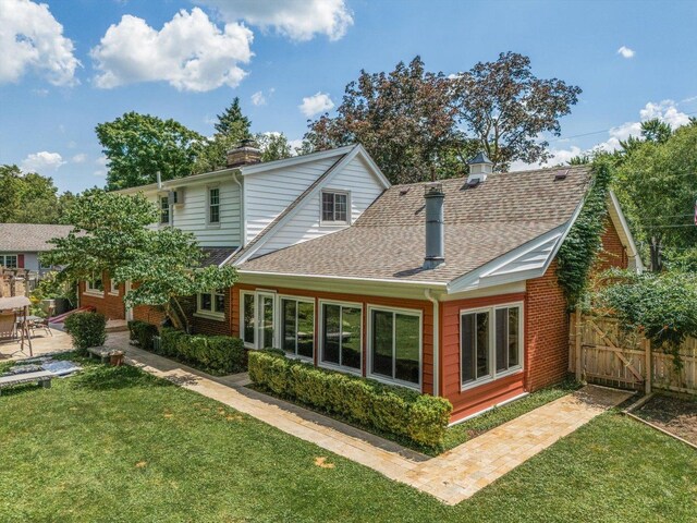 603 Shabbona Trl, Batavia, IL 60510 - rear view of property featuring a chimney, a shingled roof, a patio area, and brick siding
