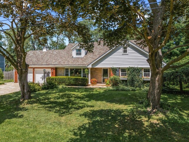 603 Shabbona Trl, Batavia, IL 60510 - cape cod-style house featuring a garage, concrete driveway, and stone siding