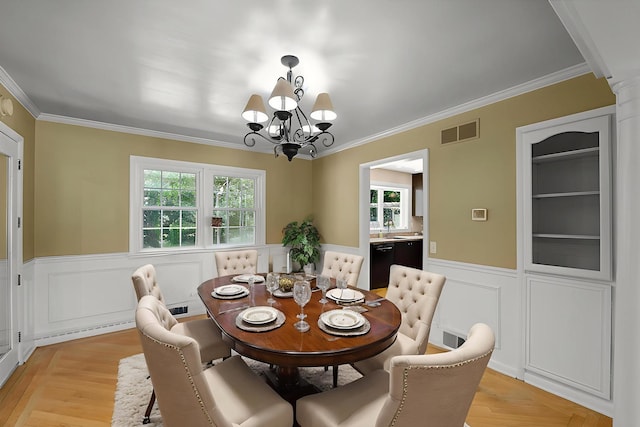 603 Shabbona Trl, Batavia, IL 60510 - dining space featuring a chandelier, ornamental molding, wainscoting, and a decorative wall
