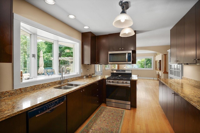 603 Shabbona Trl, Batavia, IL 60510 - kitchen featuring stainless steel appliances, light wood finished floors, dark brown cabinetry, arched walkways, and recessed lighting