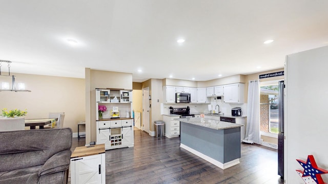508 Falmore Ln, Bolingbrook, IL 60440 - kitchen with stainless steel microwave, black range with electric cooktop, dark wood finished floors, white cabinets, and open floor plan