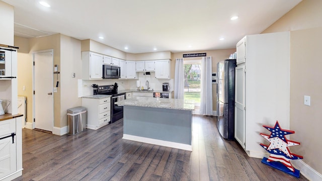 508 Falmore Ln, Bolingbrook, IL 60440 - kitchen featuring range with electric cooktop, stainless steel microwave, freestanding refrigerator, dark wood-style flooring, and white cabinetry