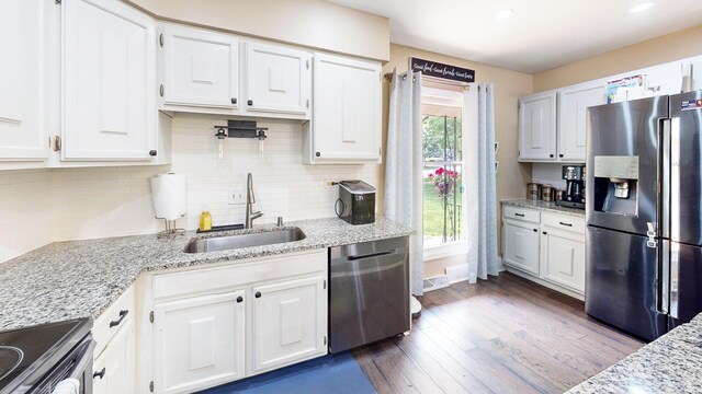508 Falmore Ln, Bolingbrook, IL 60440 - kitchen with appliances with stainless steel finishes, white cabinetry, dark wood-style floors, tasteful backsplash, and light stone counters