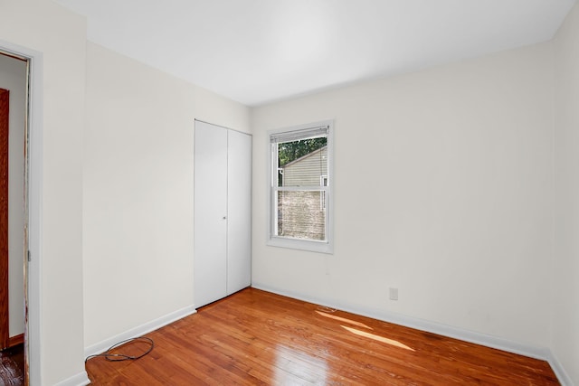 22227 Clyde Ave, Sauk Village, IL 60411 - unfurnished bedroom with hardwood / wood-style floors and a closet