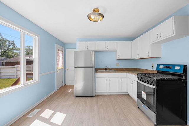 22227 Clyde Ave, Sauk Village, IL 60411 - kitchen with stainless steel appliances, white cabinetry, and light wood-type flooring
