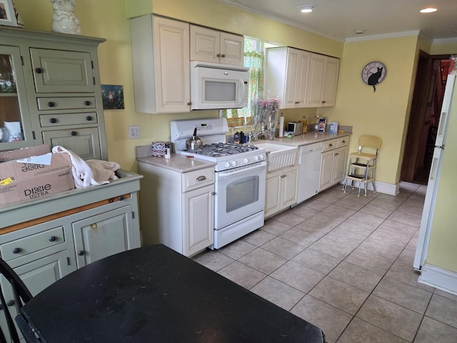 5071 W Pensacola Ave, Chicago, IL 60641 - kitchen with white appliances, ornamental molding, light countertops, light tile patterned floors, and white cabinets