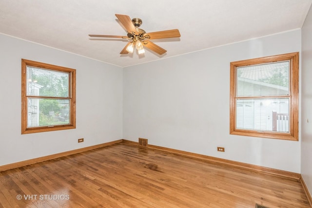 945 S Wolf Rd, Des Plaines, IL 60016 - empty room with healthy amount of natural light, wood finished floors, ornamental molding, and ceiling fan