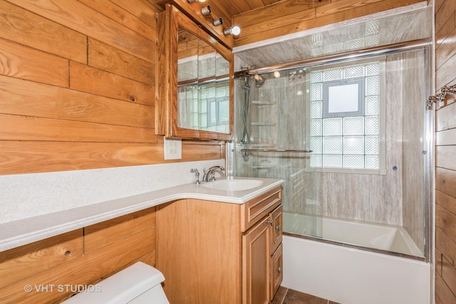 945 S Wolf Rd, Des Plaines, IL 60016 - bathroom featuring vanity, combined bath / shower with glass door, plenty of natural light, and wood walls