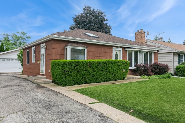 945 S Wolf Rd, Des Plaines, IL 60016 - ranch-style house featuring an outbuilding, a chimney, entry steps, a front lawn, and a garage