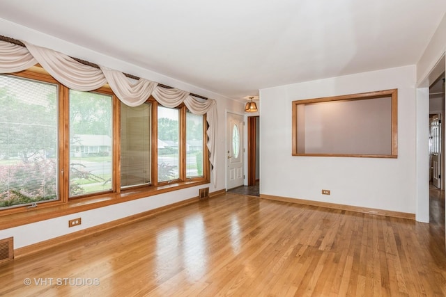945 S Wolf Rd, Des Plaines, IL 60016 - unfurnished living room with light wood-style flooring and baseboards