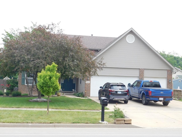 1064 N 129th Infantry Dr, Joliet, IL 60435 - view of front of house with an attached garage, concrete driveway, brick siding, and a front lawn