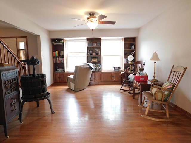 1064 N 129th Infantry Dr, Joliet, IL 60435 - living area with ceiling fan, light wood-style flooring, and stairs