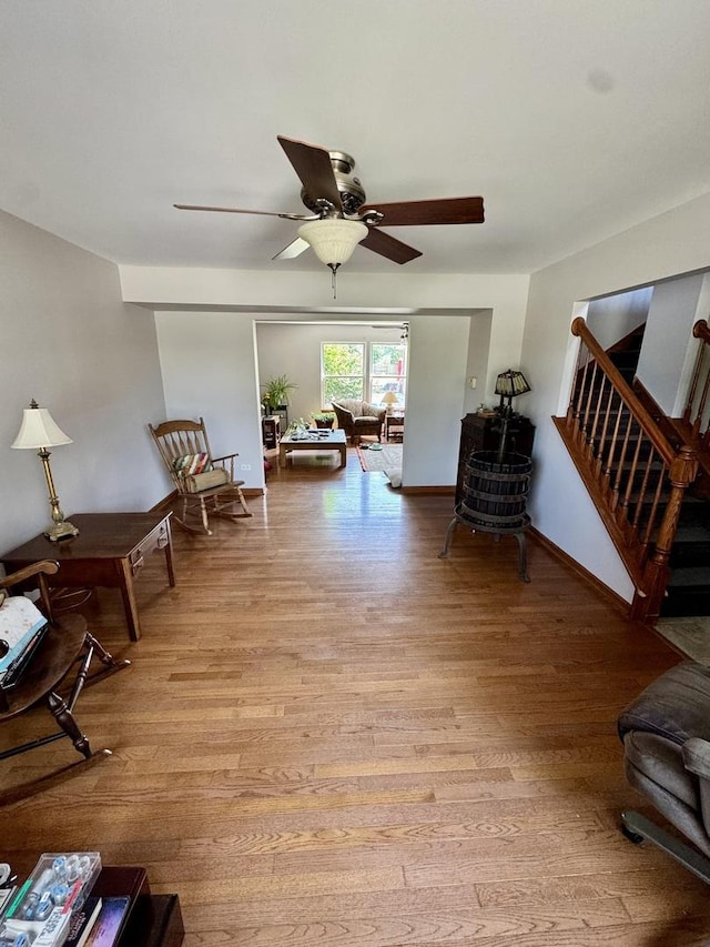 1064 N 129th Infantry Dr, Joliet, IL 60435 - living area with a ceiling fan, stairway, and wood finished floors