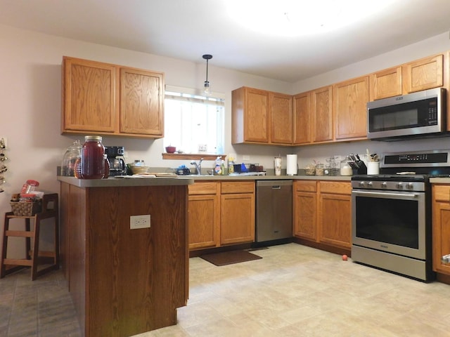 1064 N 129th Infantry Dr, Joliet, IL 60435 - kitchen with appliances with stainless steel finishes, a peninsula, decorative light fixtures, and a sink