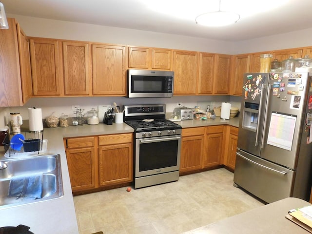1064 N 129th Infantry Dr, Joliet, IL 60435 - kitchen featuring stainless steel appliances, light countertops, and a sink