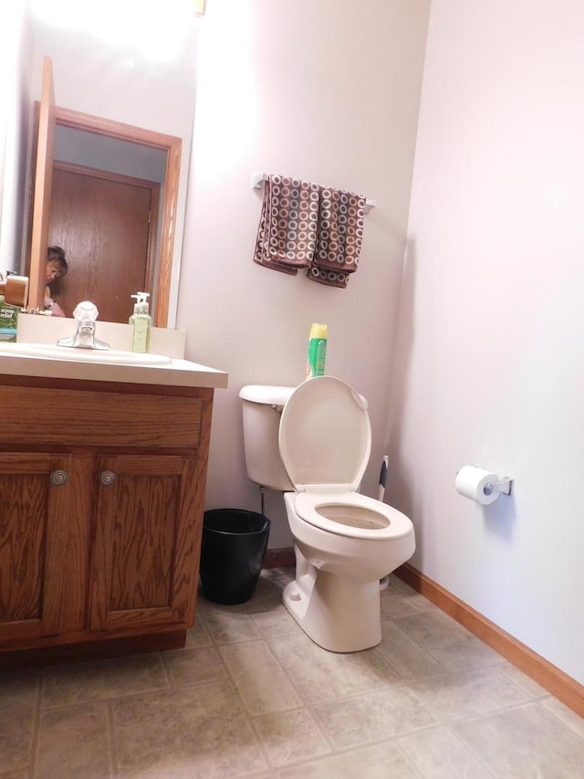 1064 N 129th Infantry Dr, Joliet, IL 60435 - half bathroom featuring vanity, toilet, and baseboards