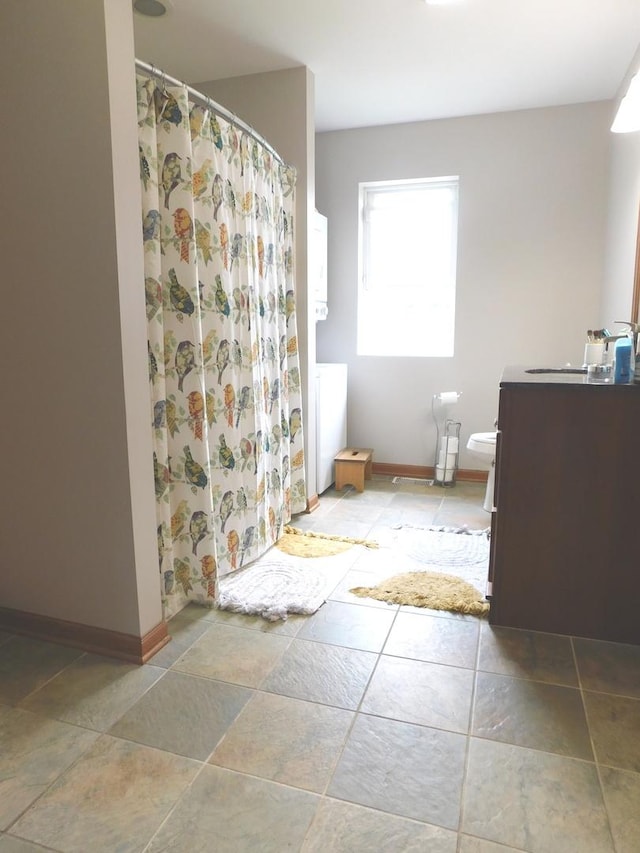 1064 N 129th Infantry Dr, Joliet, IL 60435 - bathroom featuring vanity, toilet, baseboards, and a shower with curtain