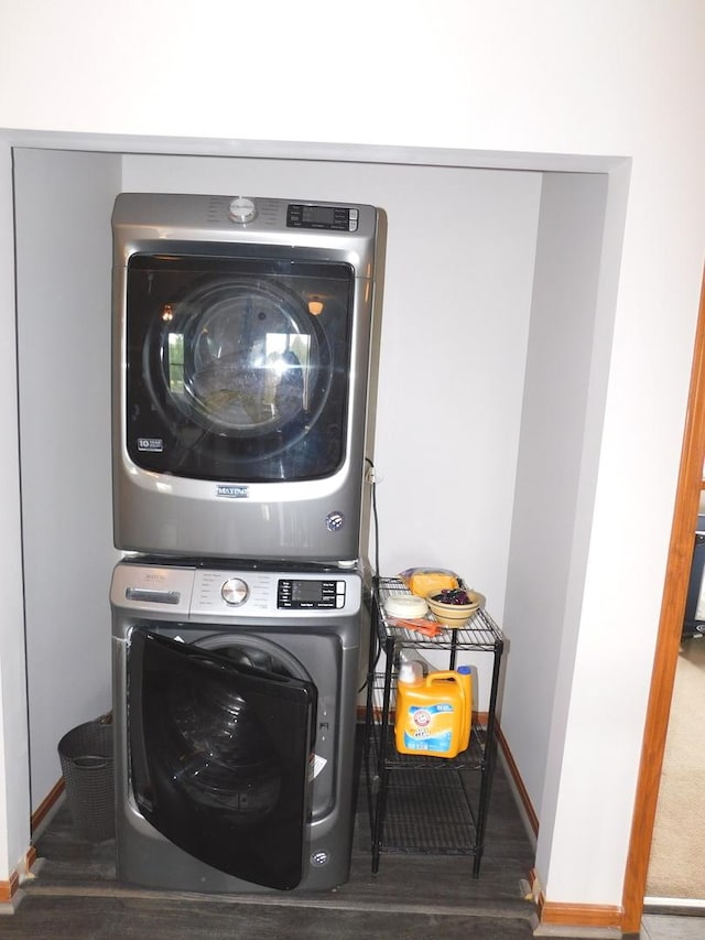 1064 N 129th Infantry Dr, Joliet, IL 60435 - laundry room featuring stacked washer and clothes dryer, baseboards, and wood finished floors