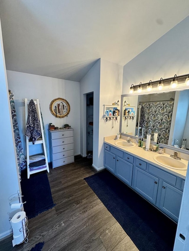 1064 N 129th Infantry Dr, Joliet, IL 60435 - full bathroom with double vanity, vaulted ceiling, and wood finished floors