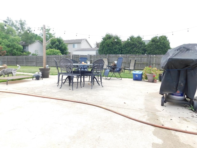 1064 N 129th Infantry Dr, Joliet, IL 60435 - fenced backyard with a patio, outdoor dining area, and grilling area