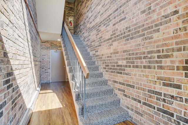 3515 Central Rd Unit 103, Glenview, IL 60025 - staircase with brick wall and wood finished floors