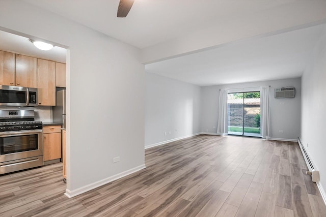 3515 Central Rd Unit 103, Glenview, IL 60025 - kitchen featuring stainless steel appliances, a baseboard heating unit, light wood finished floors, a ceiling fan, and light brown cabinetry