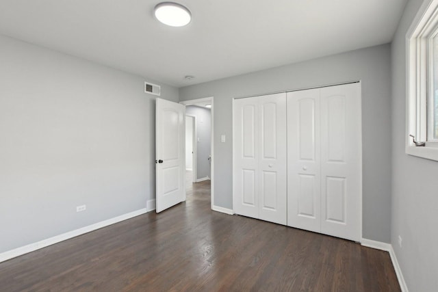 1848 172nd St, East Hazel Crest, IL 60429 - unfurnished bedroom with dark wood-type flooring, baseboards, and a closet